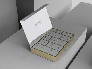 Calendar box with a hinged book-style cover and numbered compartments